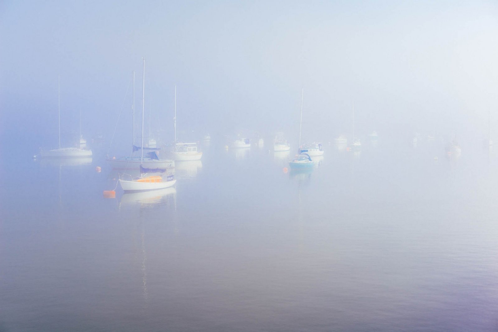 Boats in the mist, Royal William Yard, Plymouth. Plymouth, England. Photograph by Ivo Dukić.