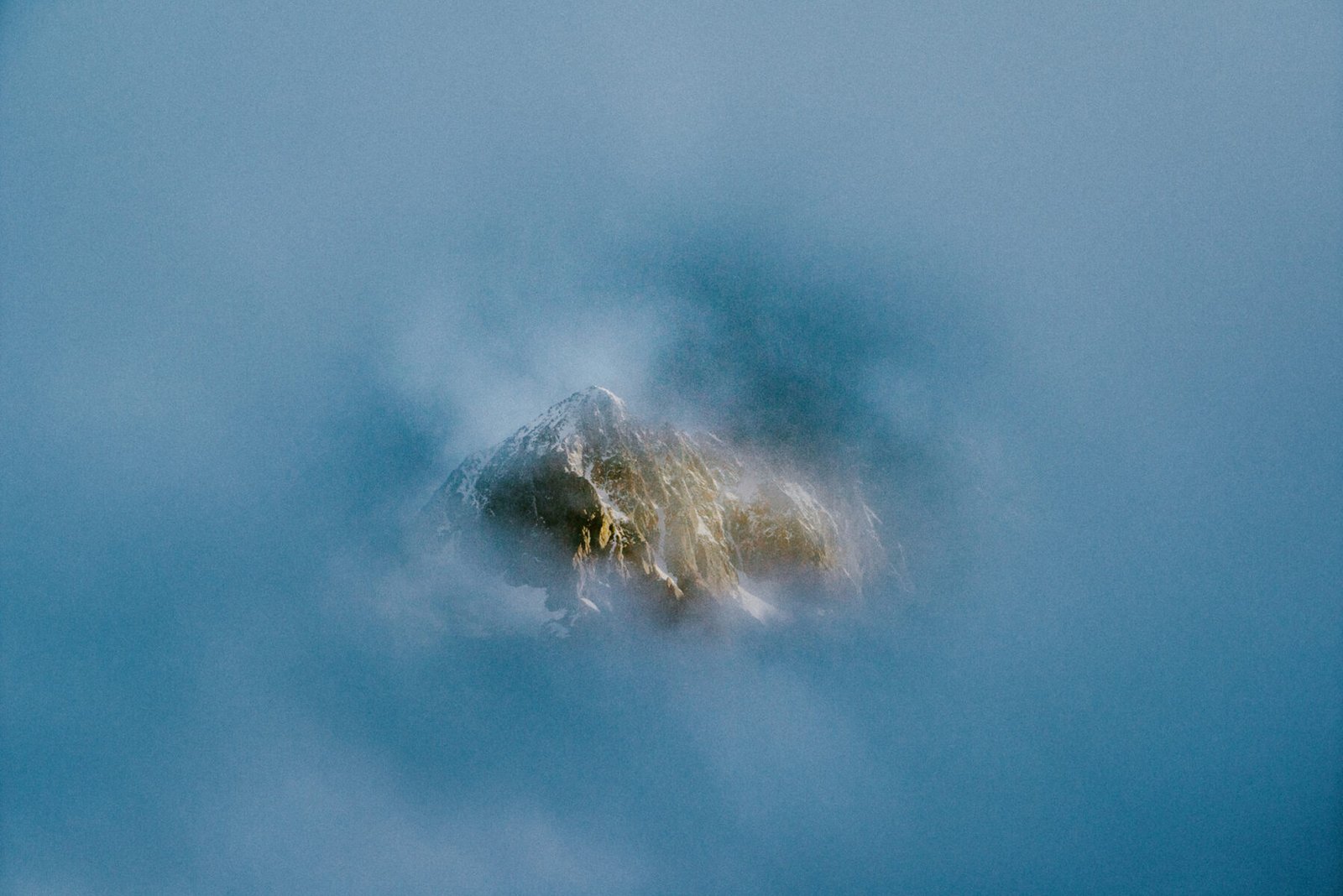 A hole in the clouds, On the road to Milford. New Zealand. Photograph by Ivo Dukić.